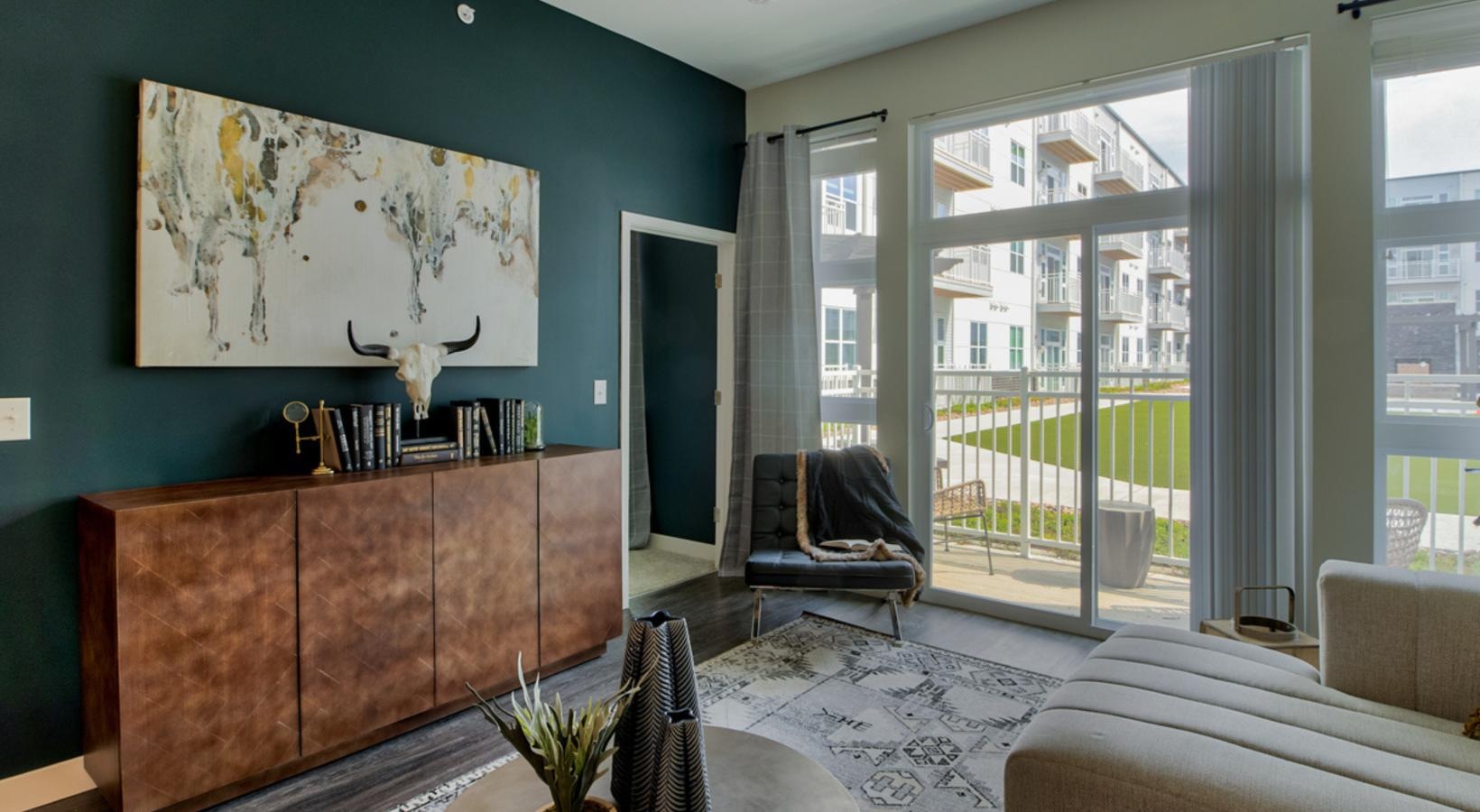 Generous living spaces with beautiful natural lighting a room with a couch and a table with chairs and a window