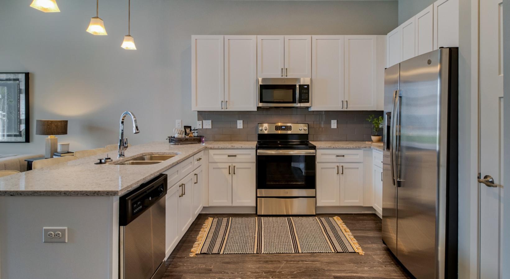Spacious kitchens with thoughtful details a kitchen with white cabinets